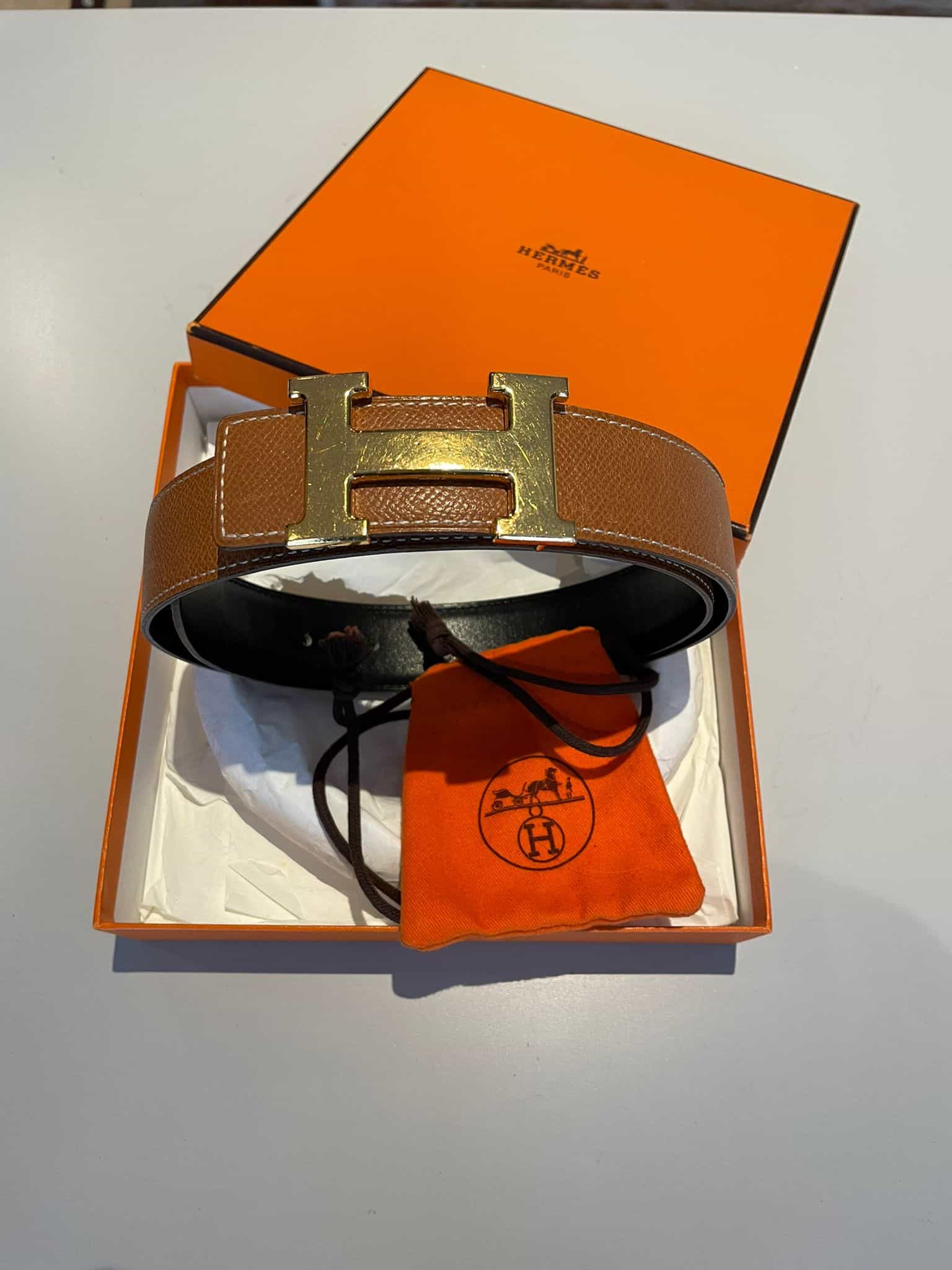Hermes “H” belt with reversible strap in black/gold with gold buckle (scratched)